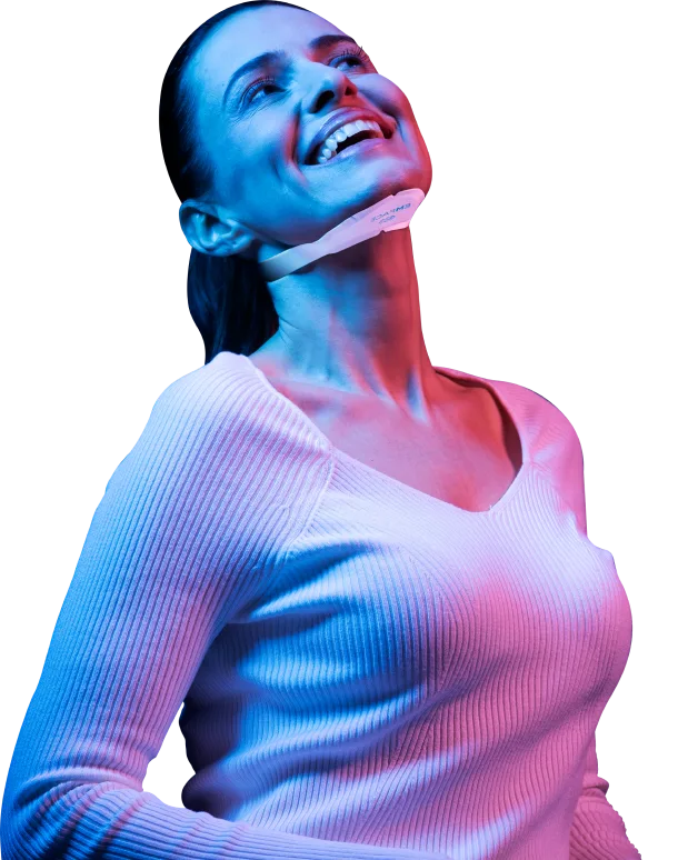 EMface facial toning Dublin - woman smiling with a facial applicator under her chin Woman smiling with a facial applicator under her chin at our Clanwilliam Square clinic, EMface facial toning Dublin